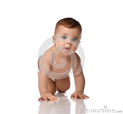 Cute little baby girl infant in diaper try to creep on floor smiling and looking aside isolated on white background Stock Photo