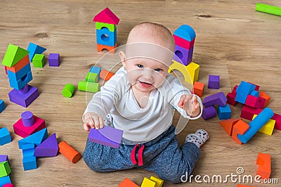 Cute little baby girl playing with colorful toy blocks Stock Photo
