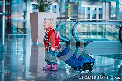 Cute little baby girl on suitcase travel in airport Stock Photo