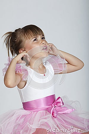 Cute little ballerina angry about the loud noise Stock Photo