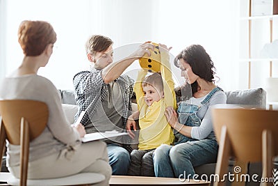 Cute little boy with ADHD during session with professional therapist Stock Photo