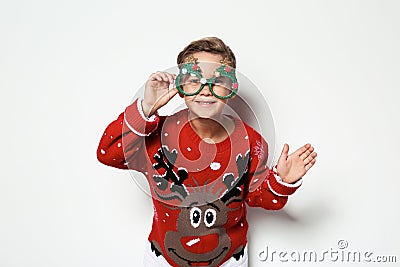 Cute little boy in Christmas sweater with party glasses Stock Photo