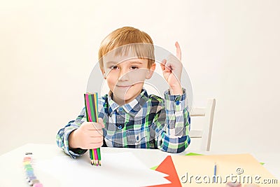 Cute little boy drawing at home. Children`s creativity. Creative kid painting at preschool. Development and education concept. Stock Photo