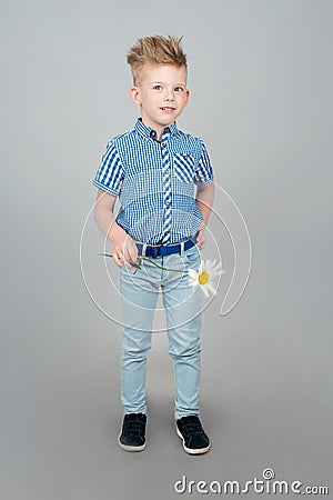 A cute little boy is dressed in a checked blue shirt. A kid with Stock Photo
