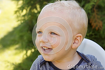 Cute little boy drinkng a glass of fresh water. Funny laughing toddler Stock Photo