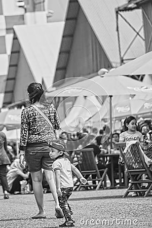 Cute little boy follow his mother, Bandung Air Show 2017 Editorial Stock Photo