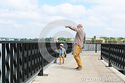 Cute little boy and his father walk in summertime Stock Photo