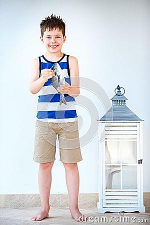 Cute little boy holding a gilt-head bream Stock Photo