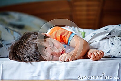 Cute little boy sleeping in a bed Stock Photo