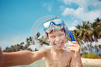Cute little boy in snorkeling mask making selfie at tropical beach on exotic island Stock Photo