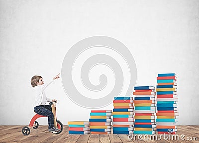 Cute boy on a tricycle, showing finger books Stock Photo