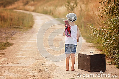 Cute little boys, holding a bundle, eating bread and smiling, wa Stock Photo