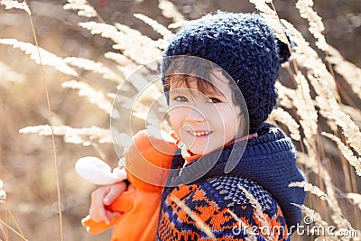 Cute little caucasian child, boy, holding fluffy toy, hugging it Stock Photo