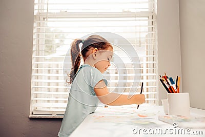 Cute little Caucasian Girl enjoying Painting Stock Photo