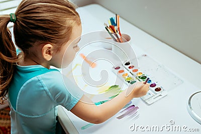 Cute little Caucasian Girl enjoying Painting Stock Photo