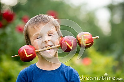 Cute little child, boy, holding a love sign, made from apples, l Stock Photo