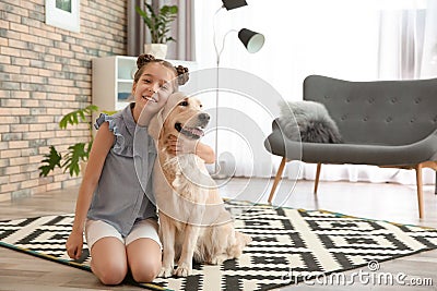 Cute little child with her pet on floor Stock Photo