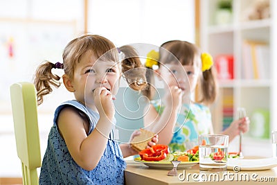 Cute little children eating food at daycare Stock Photo