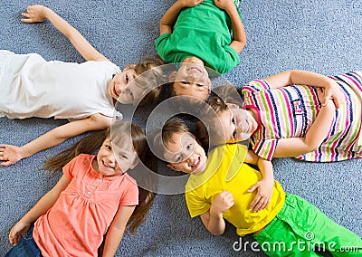 Cute little children lying on floor Stock Photo