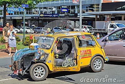 A yellow Mini, decorated for a Christmas parade in Rotorua, New Zealand Editorial Stock Photo