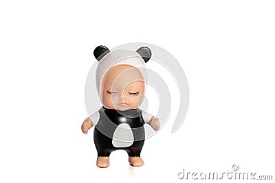 Cute little doll in a panda costume with closed eyes.Stands on a white isolated background.Collection of toys.Soft focus Stock Photo