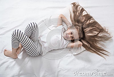 Cute little girl in bed woke up in the morning Stock Photo