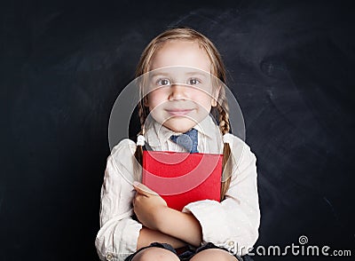 Cute little girl with book. Happy Child on empty blackboard Stock Photo