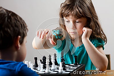 Girl and boy playing chess Stock Photo