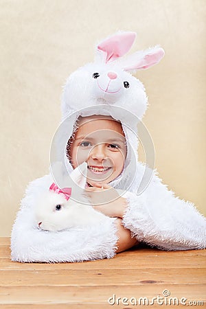 Cute little girl in bunny costume with white rabbit Stock Photo