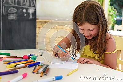 Cute little girl drawing and painting at kindergarten. Creative activities kids club Stock Photo