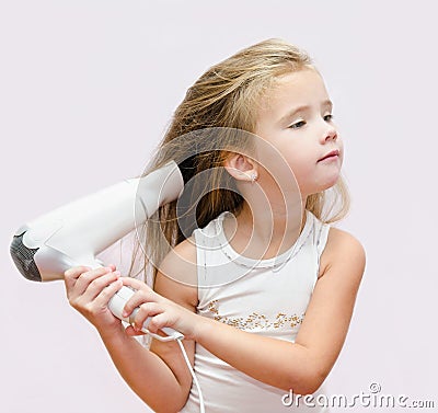 Cute little girl dries hair Stock Photo