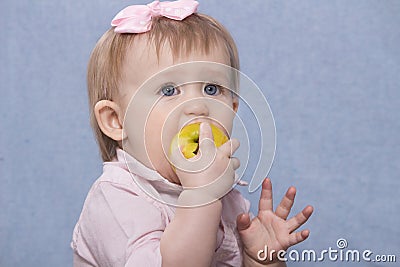 Cute little girl eating big green apple. Retro shot Stock Photo