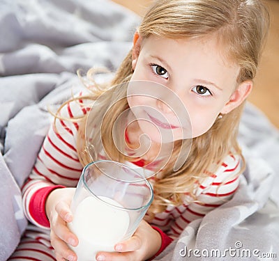 Cute little girl with glass of milk Stock Photo