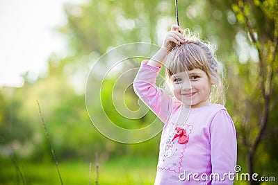 Cute little girl on the grass in summertime Stock Photo