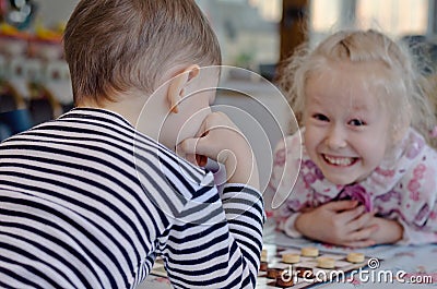 Cute little girl grinning at her brother Stock Photo