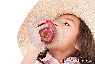 Cute little girl, hand holding, biting red apple Stock Photo