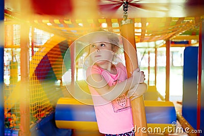 Cute little girl have fun at soft outdoor playground Stock Photo