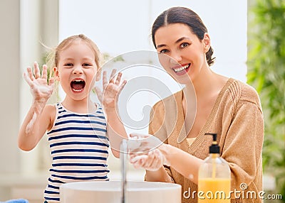 Girl and her mother are washing hands Stock Photo