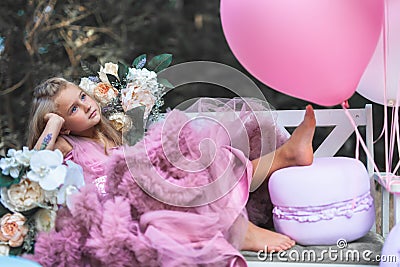 Cute little girl holds French Macaron. Confectionery concept Stock Photo