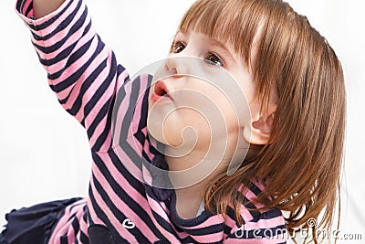 Cute, little girl lays on a floor Stock Photo