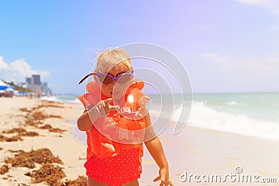 Cute little girl in life jacket pointing finger at viewer Stock Photo