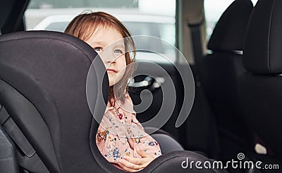 Cute little girl looks through window car. Conception of traveling and vaccation Stock Photo