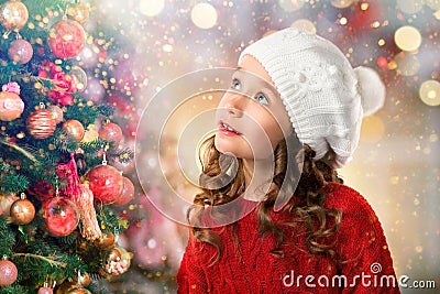 Cute little girl near Christmas tree. New Year card Stock Photo