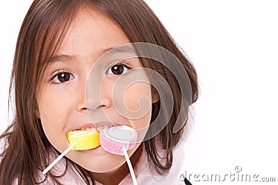 Cute little girl playing, eating sugar jelly sweet candy Stock Photo