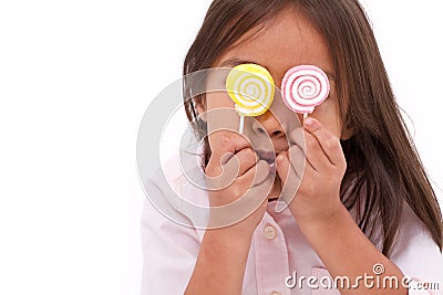 Cute little girl playing, eating sugar jelly sweet candy Stock Photo