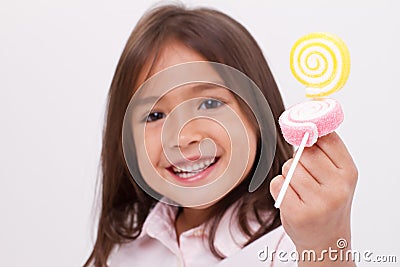 Cute little girl playing, eating sugar jelly sweet candy Stock Photo