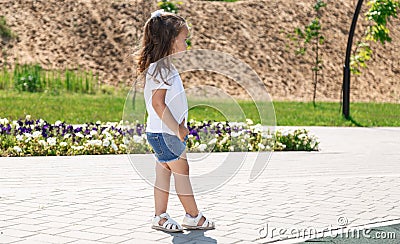 cute little girl plays outdoors on the summer , and walks around the park, happy childhood Stock Photo