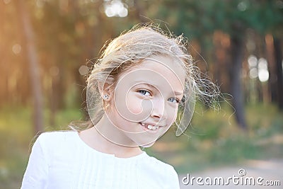 Cute little girl of preschool age in nature. Portrait with positive emotions. Stock Photo