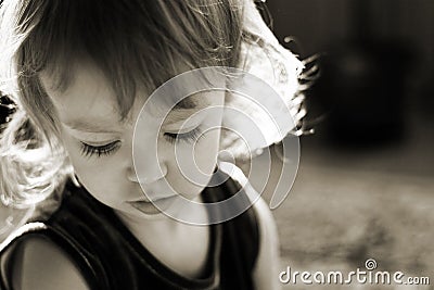 Cute little girl in the rays of sun Stock Photo