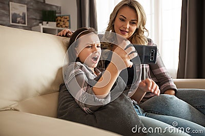 Cute little girl shocked after watching a disturbing online video Stock Photo